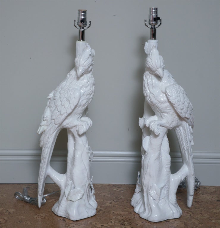 Large and dynamic pair of ceramic parrot lamps.  The lamps are sculptural and detailed three dimensionally.