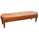 A rustic bench with upholstered seat