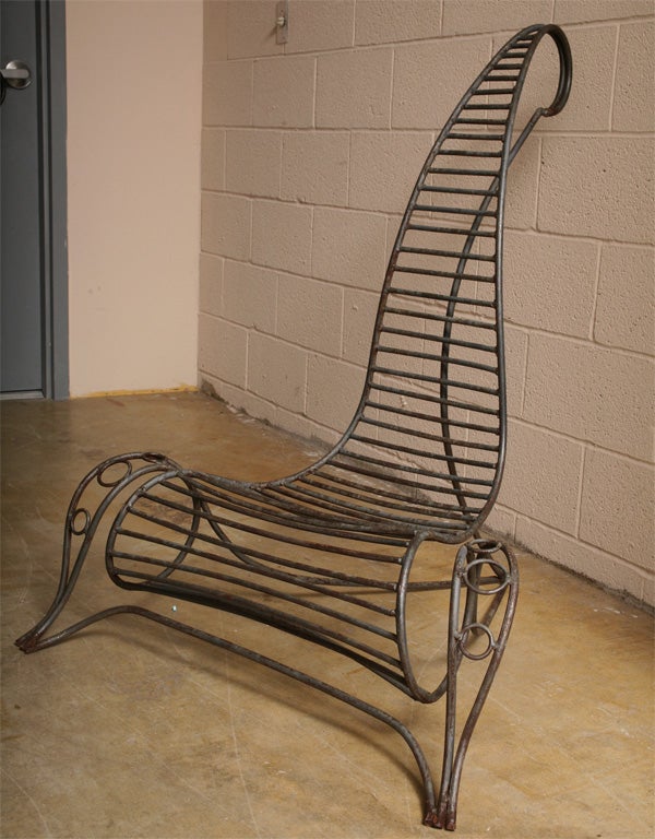 Interesting set of four wrought iron chairs in the style of Dubreuil They form an elegant sculptural grouping, fine for indoors or outdoors.