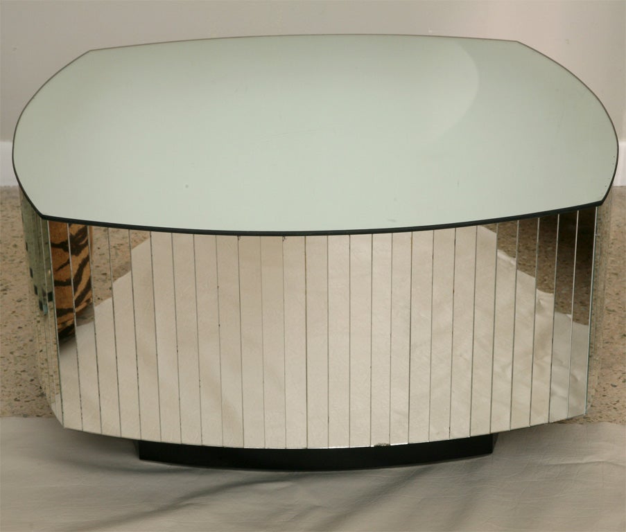 Don't know why these mirrored coffee tables were so popular in Miami, circa 1970...but we still love 'em! 3/4 inch-wide mirror strips encircle this rounded square, diminutive, coffee table with mirrored top.