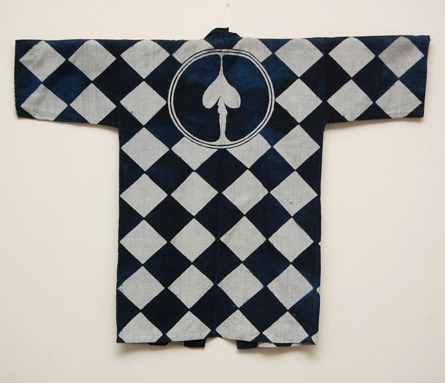Very graphic and bold checkered pattern with Indigo resist-dyed on hand woven cotton. On the collar on the front of the jacket, in Japanese characters it says 