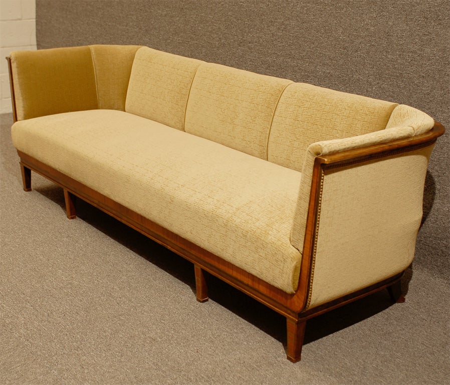 A very special Deco sofa beautifully crafted in dark flame birch with golden satinwood inlay.  Completely restored and newly upholstered in Donghia's plush 