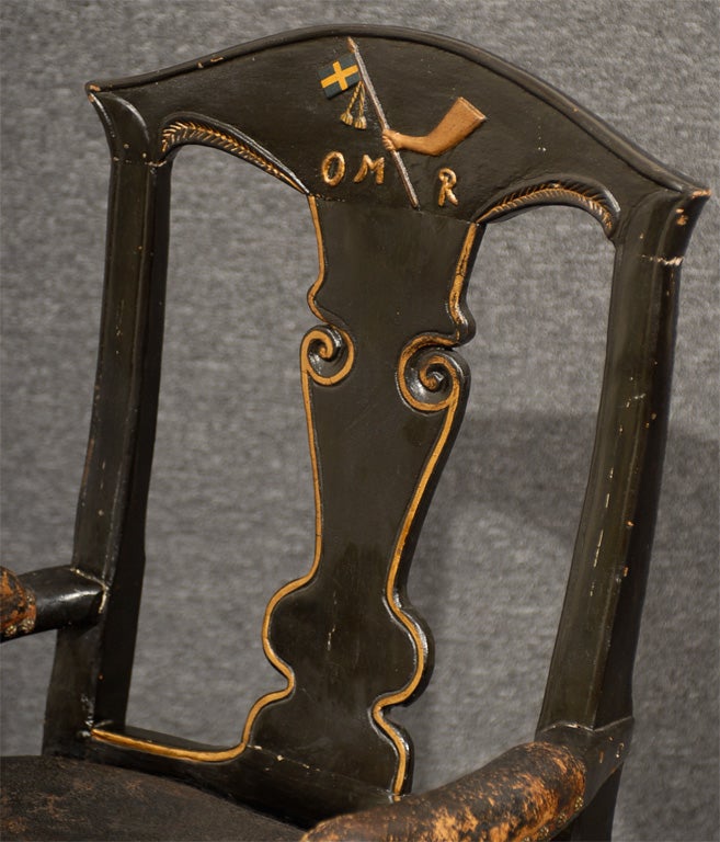 Hand-carved captain's chair in black with gold trim with Swedish flag.  Exact provenance and meaning of symbols and letters is unknown.  It is believed that this chair was created for the captain of a ship.