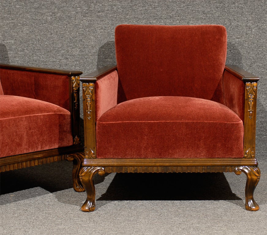 Pair of dark birch book-matched paneled and carved arm chairs newly upholstered in claret mohair.  Cushions have eight-way hand-tied springs and new recycled foam.

Wood is darker than seen in photographs.  Refer to first four photographs for