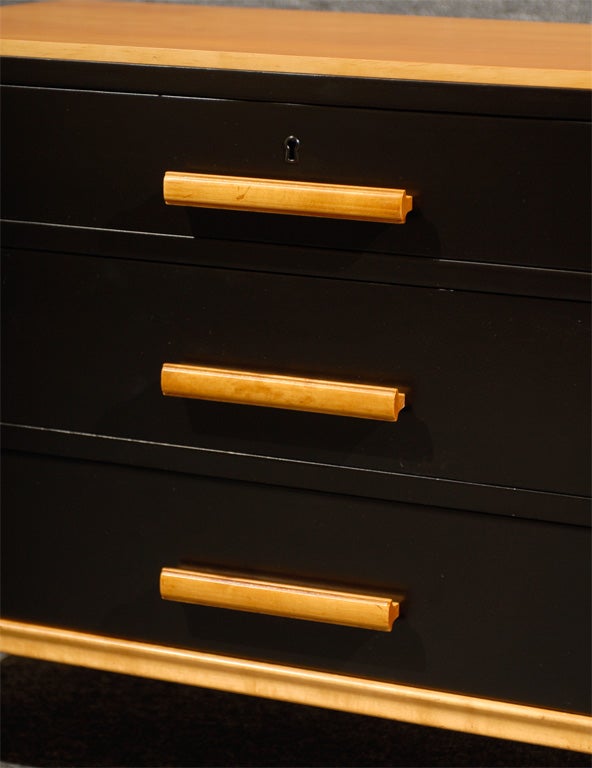 Black lacquer and golden birch three-drawer chest.

Key is not included and is not needed to operate drawers.