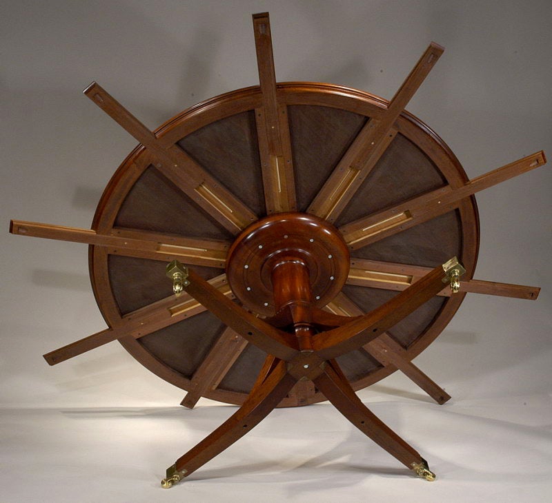 Mahogany An exceptional hand made mahogany round dining table with semi-circular leaves. For Sale