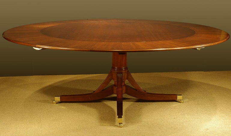 An exceptional hand made mahogany round dining table with semi-circular leaves. For Sale 1