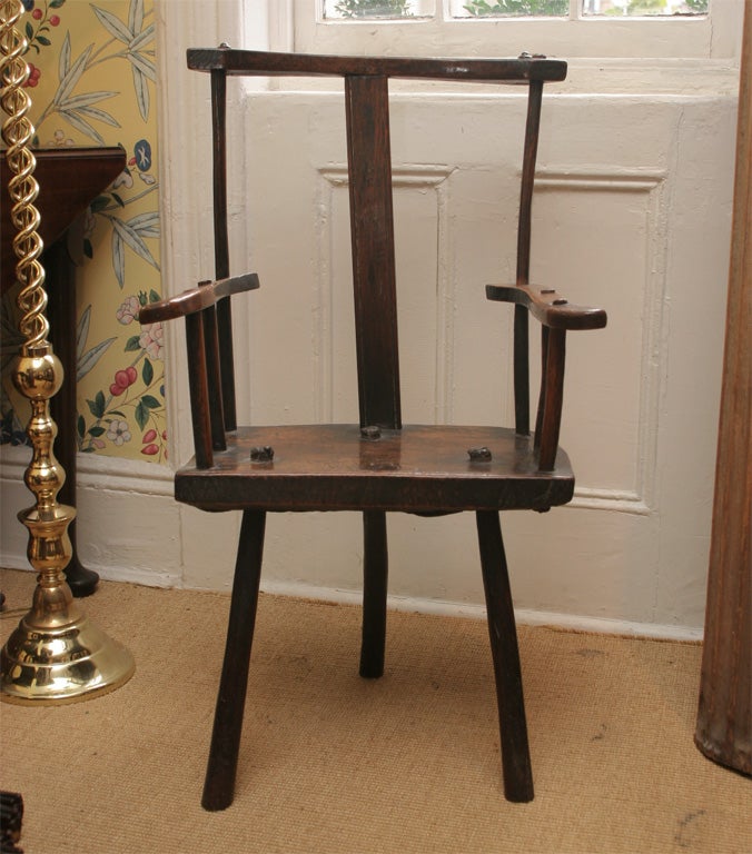 A rare English elmwood and oak three legged shepherd's chair. Circa 1780-1800.