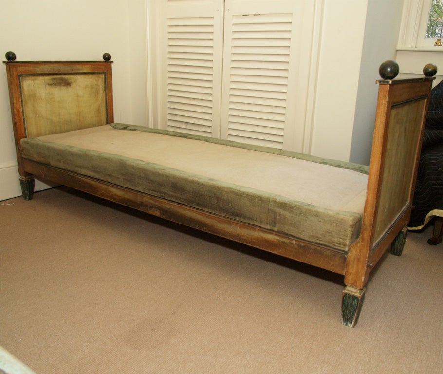 A Directoire styled daybed with original paint. Made in France in approximately 1830. The base is upholstered in original velvet. It would have had a loose cushion on top.