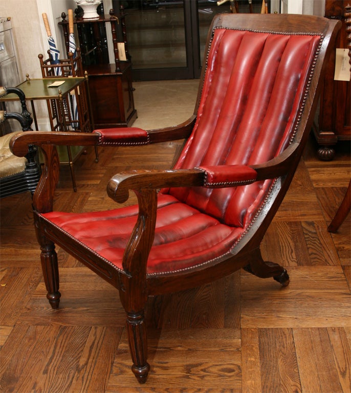 Anglo Colonial Calamander Wood Planters Arm Chair in Red Leather with Gently Sloping Channeled Back, Scrolled Padded Arms, Nailhead Detailing, and Reeded Front Legs.  Anglo India, Mid 19th Century.<br />
<br />
25 inches wide x 29 inches deep x 37