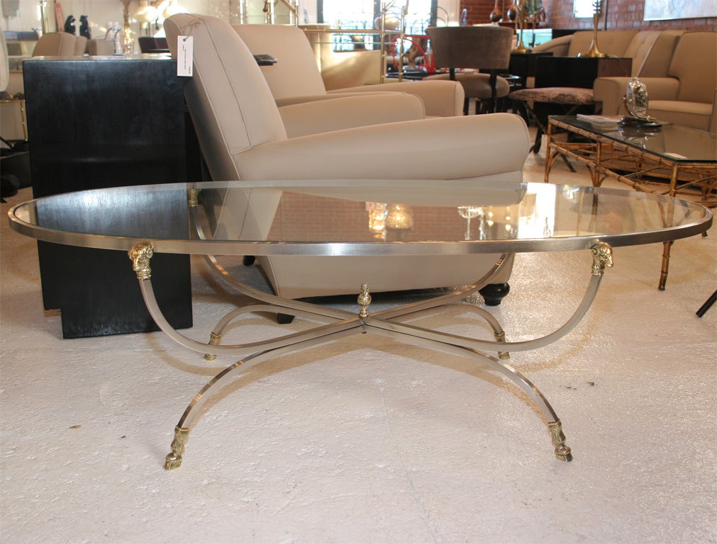 Oval Steel and Brass Rams Head Coffee Table with glass insert top.