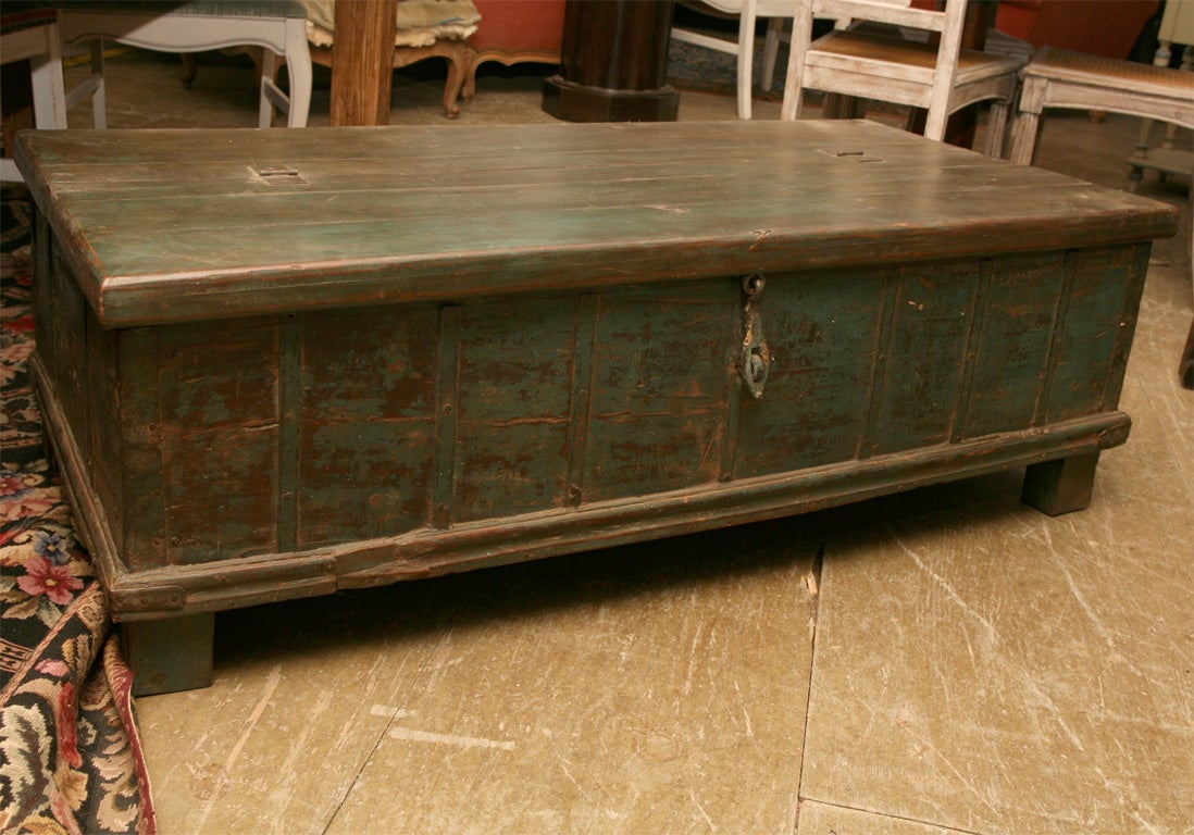 Extremely handsome painted indian trunk to be used as a coffee table.  Wonderful patina and original hardware.