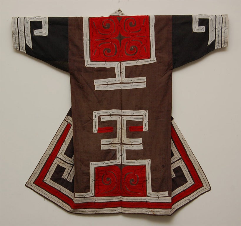 Very strong color and striking contrast of Ainu robe in the early 20th century. The Ainu were traded these fabrics from the main land of Japan.