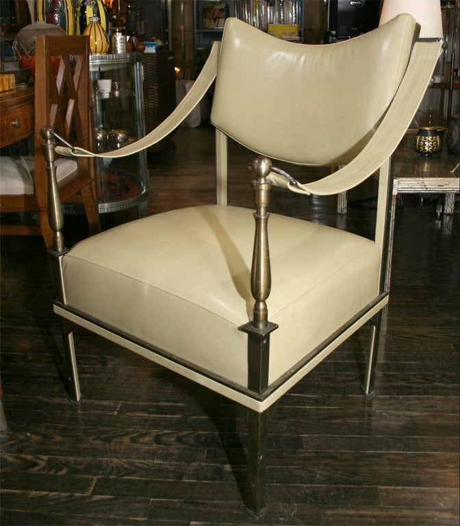 Bronze and leather armchair with sling leather arms and shaped leather upholstered back, by Andre Arbus, French, 1970's<br />
35 3/4