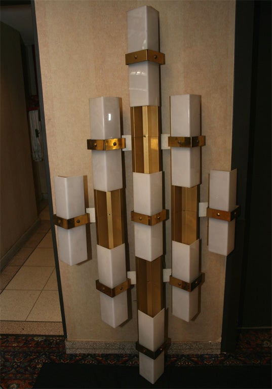 A pair of 1950s spectacular pair of sconces with a modernist five-element gilt metal structure and white perspex shades.