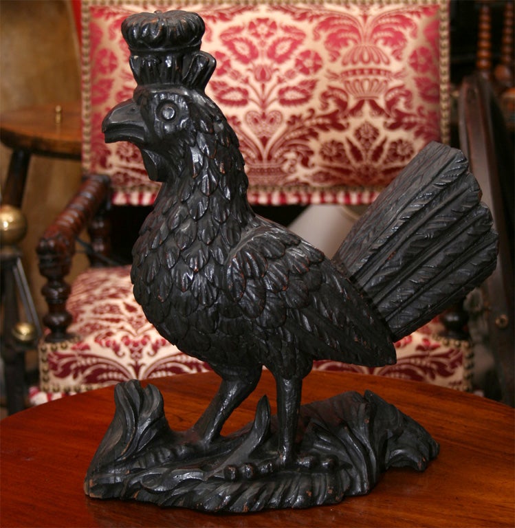 An early 19th century French carved bantam sporting a crown, well carved in pine. Good detailing to face, plumage, tail feathers and feet. Possibly originally from a ring toss game, which often featured this motif.