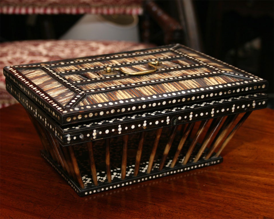 An Anglo-Indian box of porcupine quills in a tray shape with a lid.  Elaborate bone inlaid detailing throughout, including an elephant and the name of the town where the tray was made, Matura in Ceylon, famous for its inlay work.