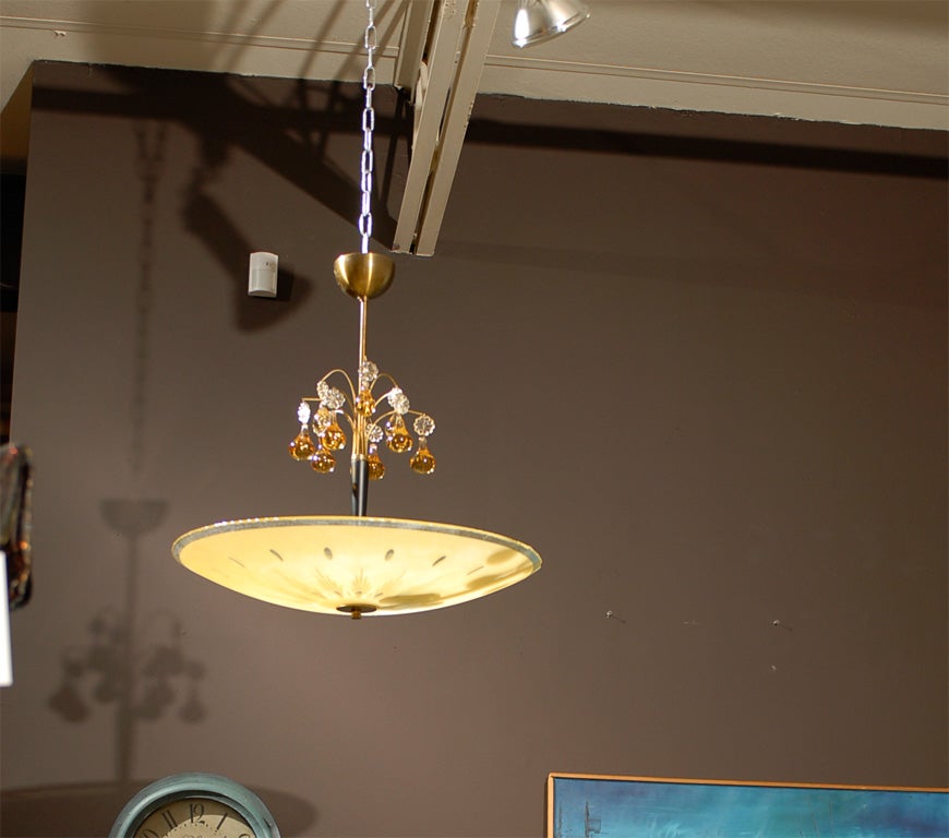Pale gold etched bowl chandelier with amber and clear crystal drops on a brass and wood stem.



Brass stem can be shorted for no extra charge and lengthened for a nominal fee.



Please contact us with any questions!