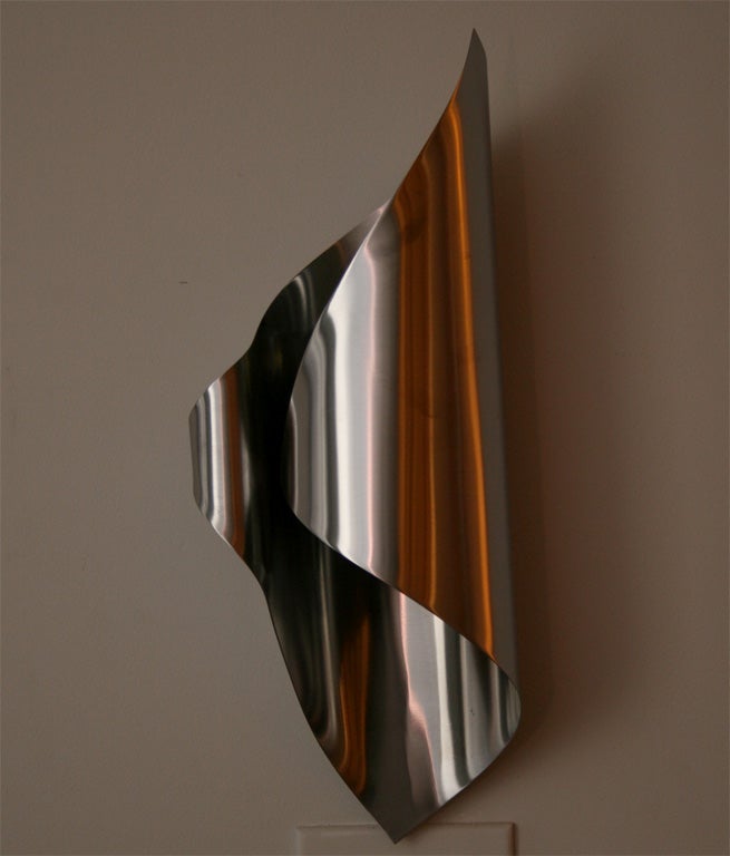Elegant flame shaped sconces by Charles, made of a single rolled pieces of stainless steel. One-light.