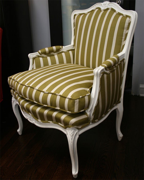 Ivory lacquered armchair upholstered in green and Ivory striped linen.