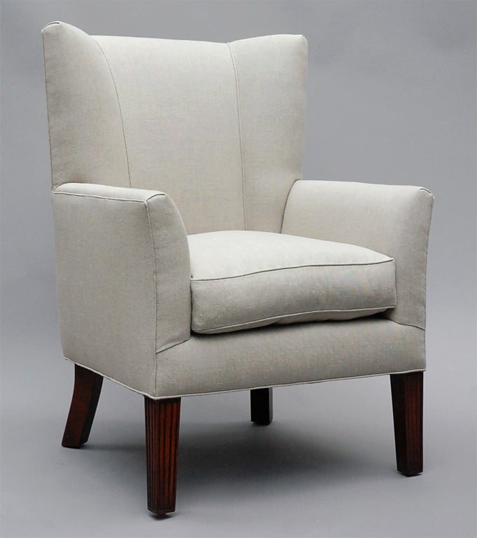 The Ellsworth by Lee Stanton Editions is an elegant and modern wingback chair with tapered reeded legs. Upholstered in cream-colored Belgian linen or customer's own material (COM), a 25/75 down envelope and foam core insert are included. $150