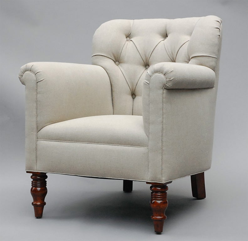 The Geffrey by Lee Stanton Editions is a modern yet traditional arm chair with rolled arms, tufted back and turned wood front feet, upholstered in Belgian linen or customer's own material (COM). $150 additional for casters. 

LEE STANTON EDITIONS,