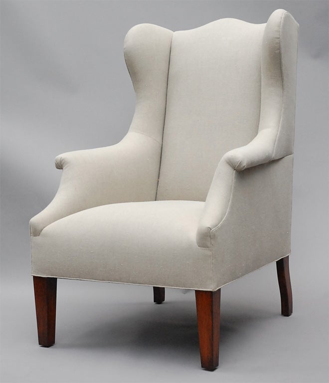 The Somerton by Lee Stanton Editions is a traditional yet contemporary armchair with winged rolled arms and tapered wood feet, upholstered in cream-colored Belgian linen or customer's own material (COM). $150 additional for casters.

LEE STANTON