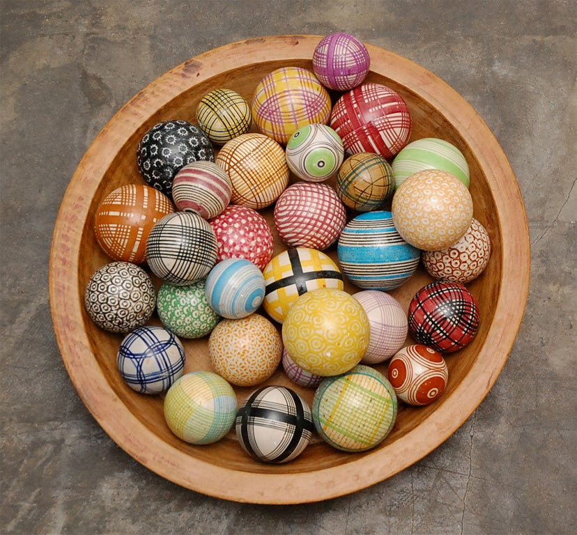 Played indoors in Scotland these bowls (or balls) were used in the game of carpet bowls. We have these brightly patterned balls in three sizes so the whole family may play. You could fill a wooden bowl or put a ball on a stand, either way they will