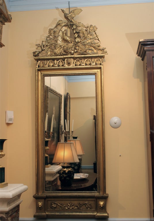 This mirror has carved details similar to a suite of seating furniture commissioned for the apartments of Maria Louisa of Bourbon, the Queen of Eturia. On view at the Palazzo Pitti in Florence. The suite of seat furniture was a royal commission made