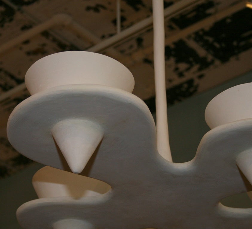 Cloud-shaped hanging light fixture of plaster.  Five light sources inside upward-facing cones.  
Lead time: 12 to 15 weeks.
