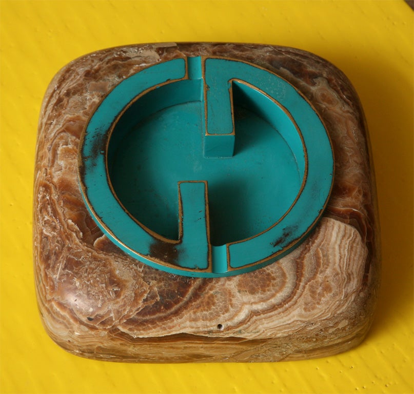 Fabulous vintage Gucci ashtray has turquoise enamelled paint finish over brass, set into a marble base. Gucci imprint suede bottom, with original maker's label.