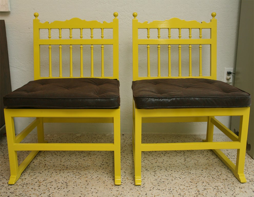 A bit Asian, a bit Spanish, a whole lot of POW with this pair of vintage occasional chairs, lacquered in vivid mustard yellow. Seat cushions are covered in faux tooled leather.