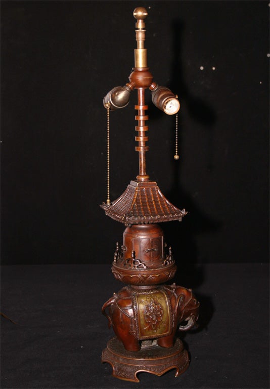 Bronze elephant and temple motif lamp