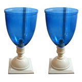 pair of dark blue globes on handpainted white wooden stands