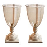 pair of glass globes on wooden stands