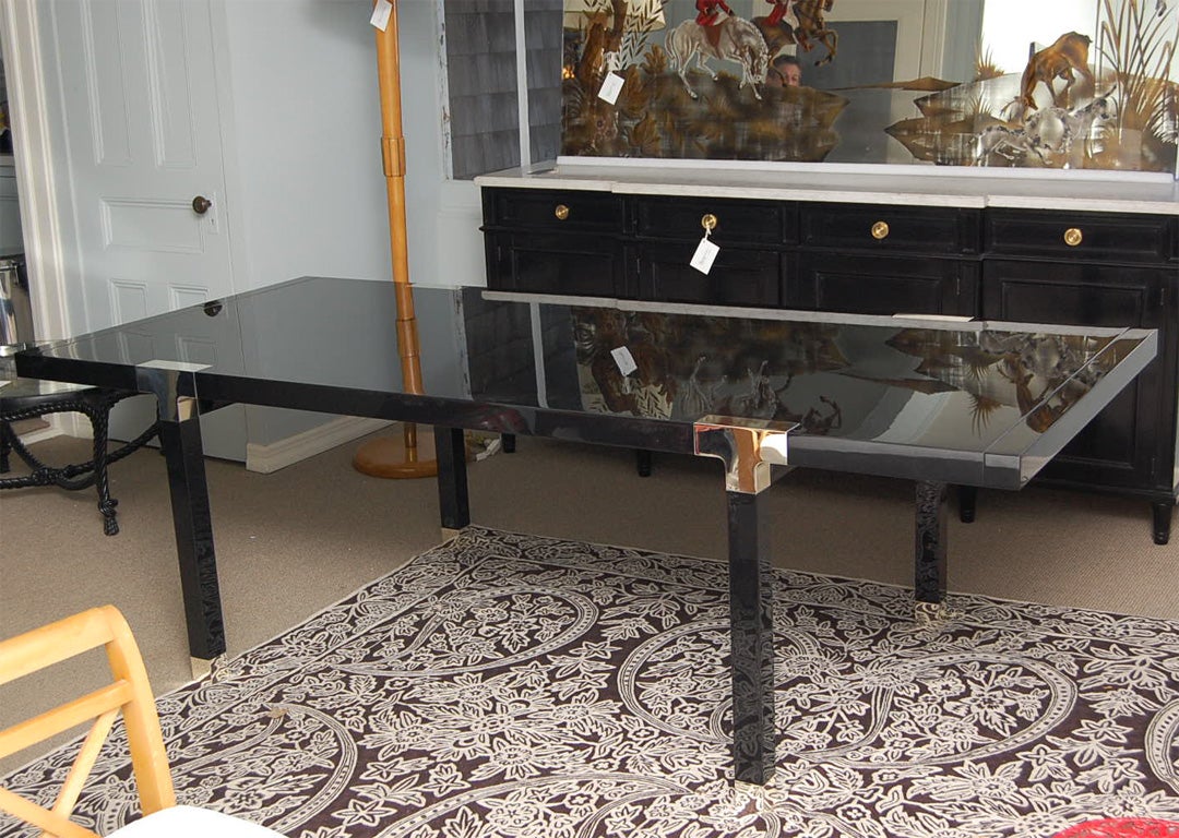 Elegant dining table/executive desk by Armani Casa (no longer in production); high-gloss black lacquer with nickel t-shaped joinery and sabots