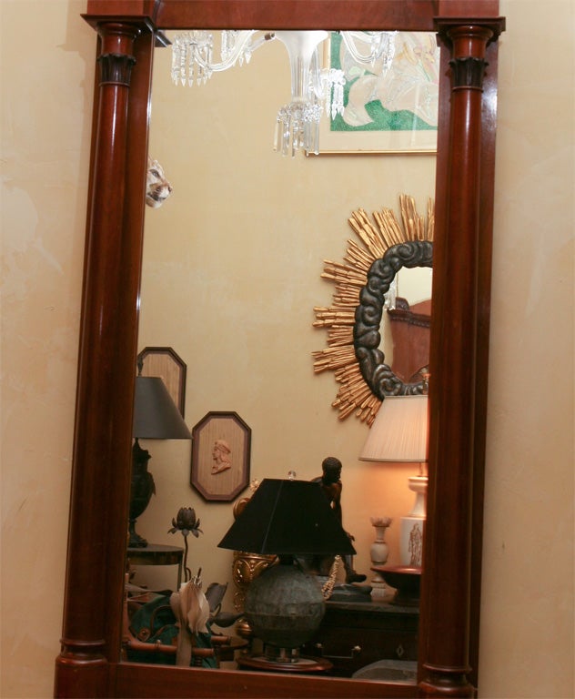 A very fine German pier mirror having a good color and finish. The frame made of walnut finished in a rich warm brown has mellowed to a very nice color. The carving though space is very detailed and bold.