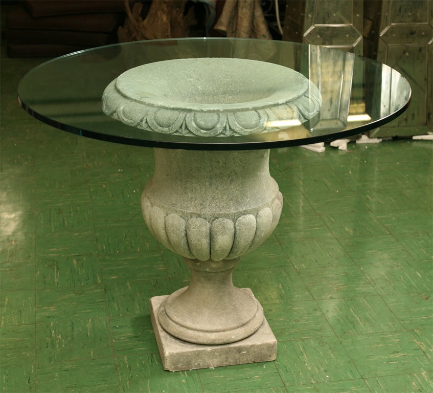 This large carved Vicenza urn now used with a glass top to create a center table is of an impressive size. The table would be perfect in a modern interior with a classical bent. The urn has a nice surface and patina and the slight irregularities of
