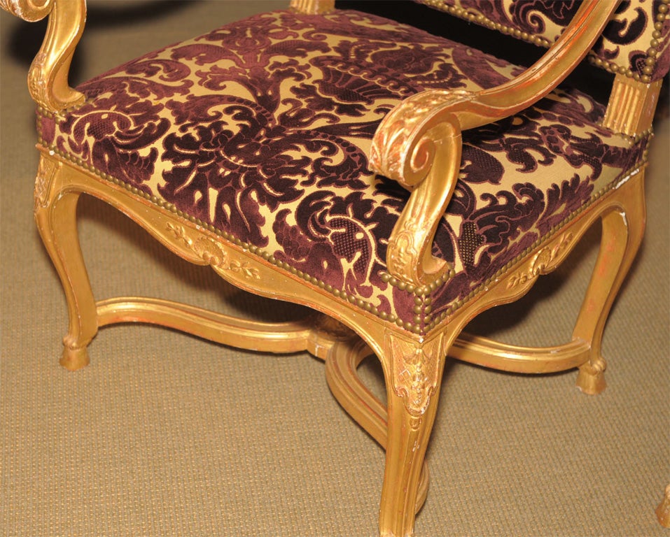 A Bold Pair of Carved Gilt Wood Régence Style Fauteuils