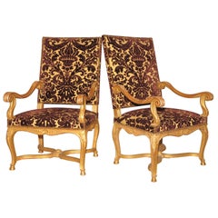 A Bold Pair of Carved Gilt Wood Régence Style Fauteuils