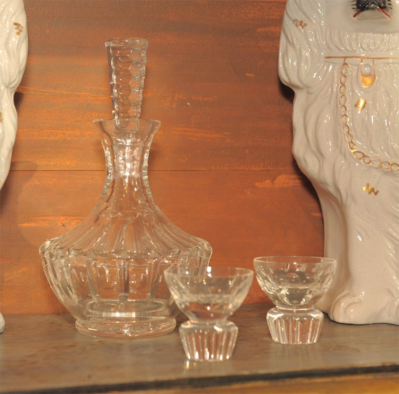 Including a carafe with stopper and two glasses made of hand blown etched crystal; known as “luxury glass” for the amount of manual labor involved.  <br />
Decanter:  9”H X 5” Dia<br />
Glasses:  2.25”H x 2.25” Dia