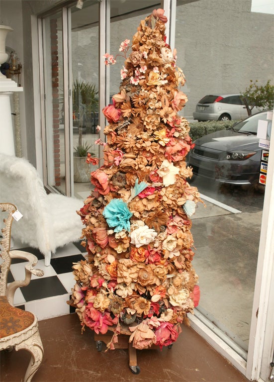 Whimsical and unusual crepe paper tree. Hundreds of handcrafted crepe paper flowers adorn the chicken wire and wood frame.