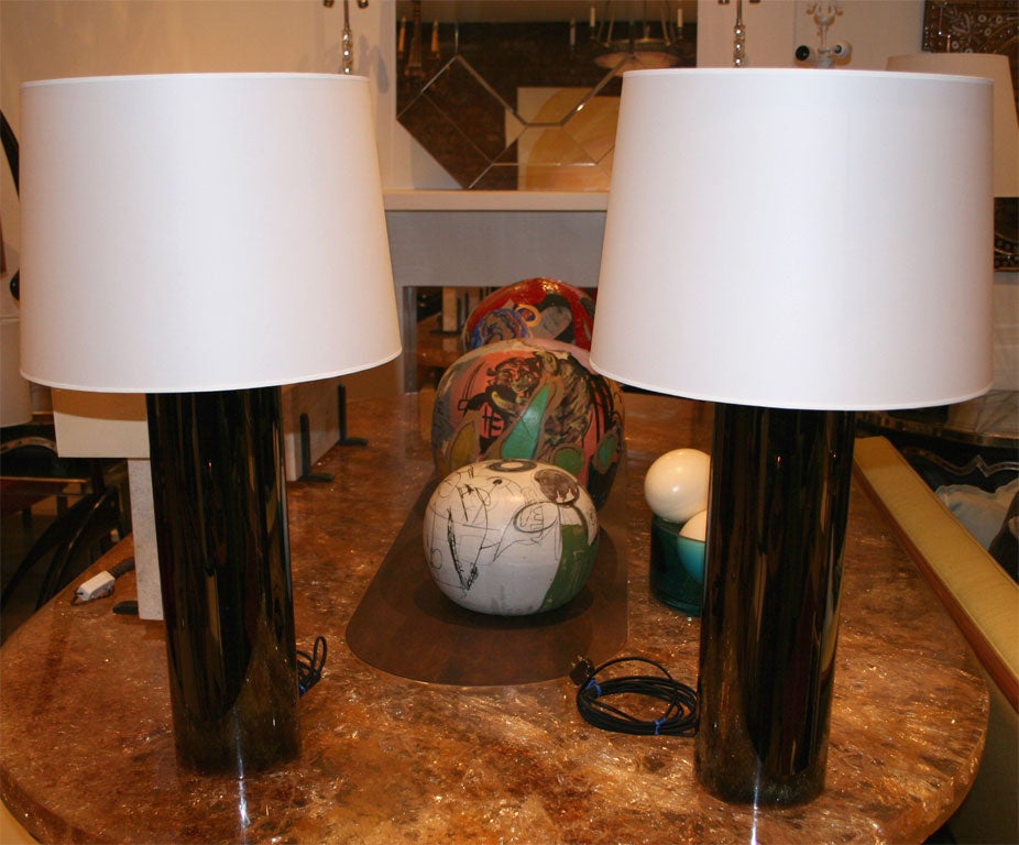 Pair of cylinder lamps with three lights. The finish is black nickel.