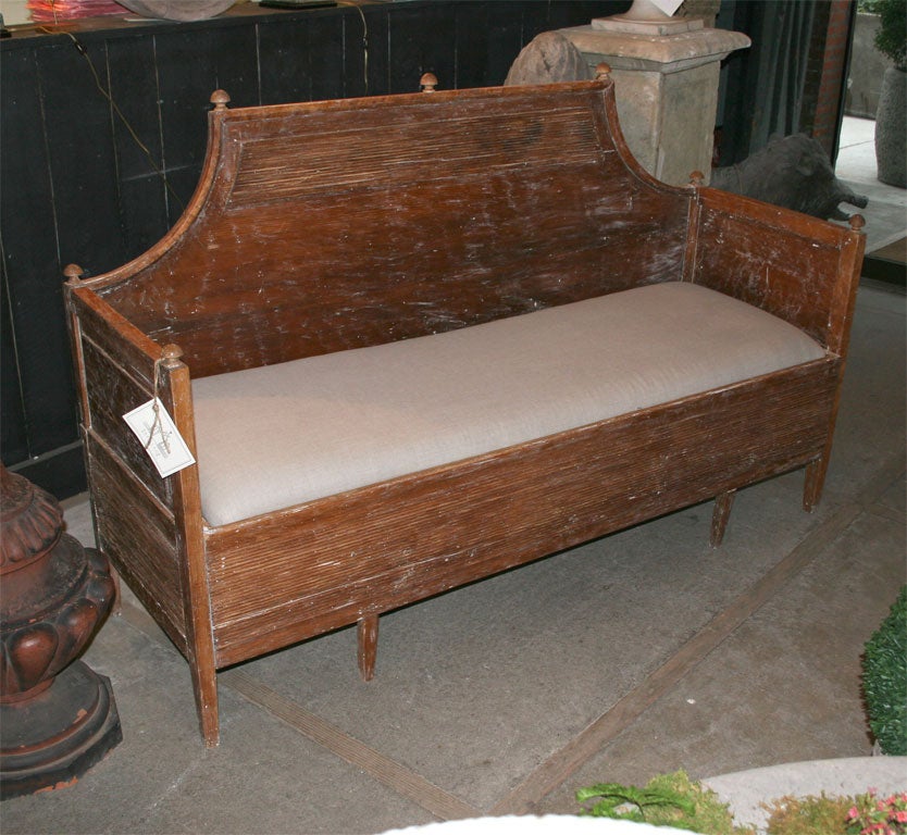 This beautiful 19th century trundle bed has a newly upholstered seat in linen