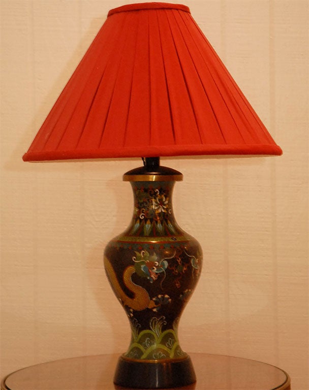 Striking pair of chinese cloisonne vases mounted as lamps with new red pleated shades and black silk twisted cords. Great clear colors on black ground