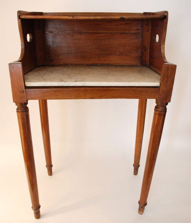 19th century fruitwood book table with marble shelf. Supported on turned legs and a removable top shelf.