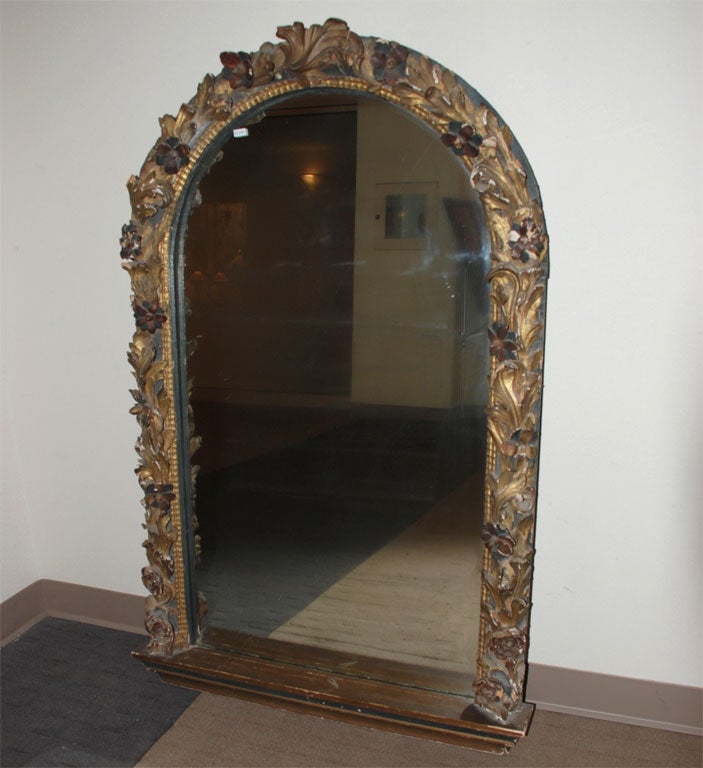 A wonderful carved paint and giltwood mirror with floral carvings. Original surface and old mirror.