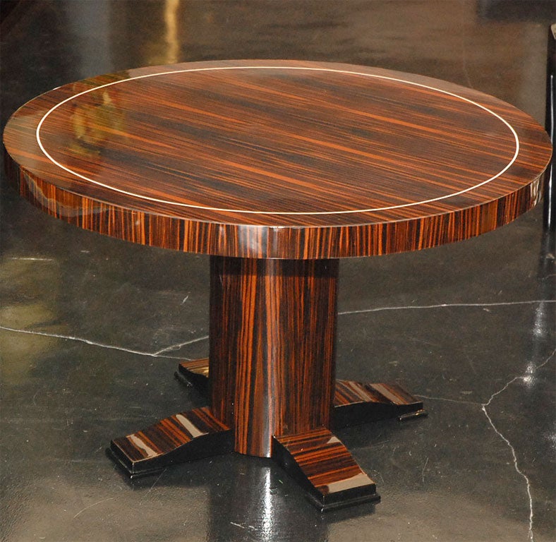 Table d'appoint moderniste Art Déco en ébène de Macassar avec incrustation d'os circulaire sur la surface. Détails en laque noire sur le côté des pieds.