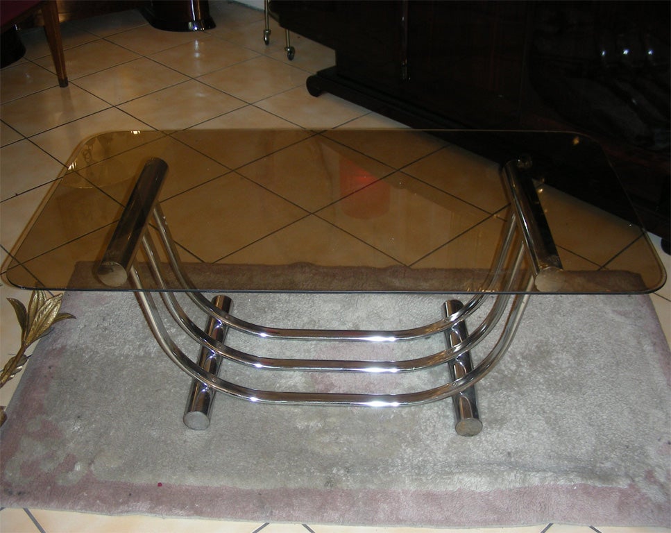 1970s coffee table with base in chromed metal and top in smoked glass. Signed but difficult signature to read.