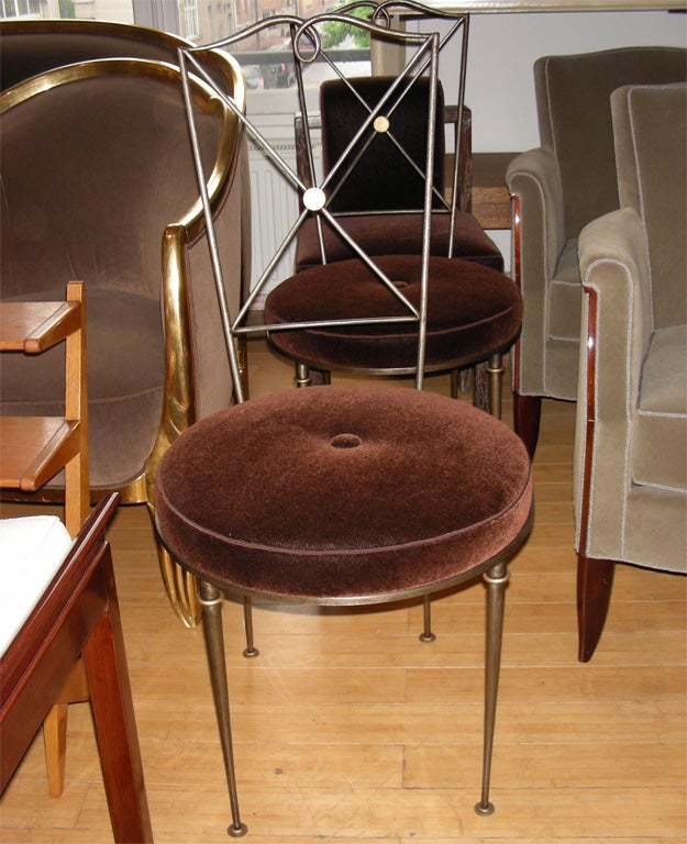 Four 1940s chairs by Raymond Subes in gilt wrought iron.